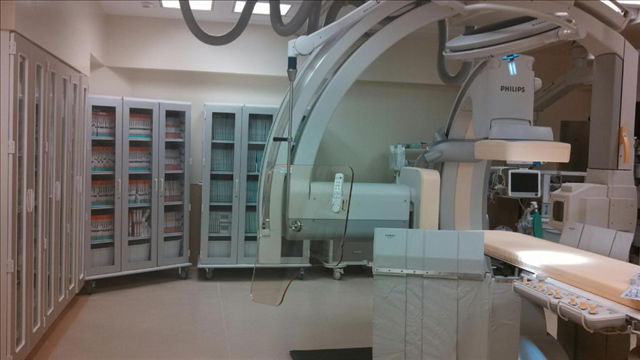 A room with medical equipment and cabinets